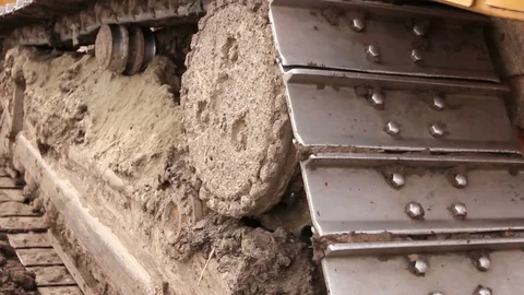 Crawler's tracks, bulldozer machine is leveling construction site Stock Footage
