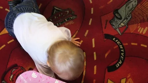 Crawling and playing toddler - top view with camera floowing Stock Footage 83751109