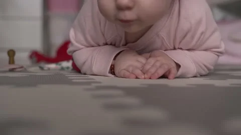 A crawling infant, lying on the floor in the room Stock Footage 162342962
