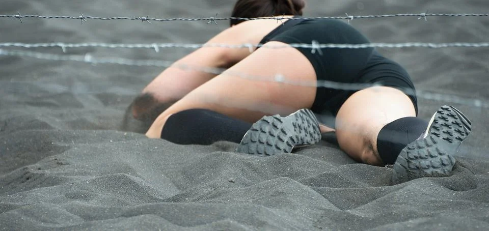 Crawling, passing under a barbed wire obstacles Stock Photos
