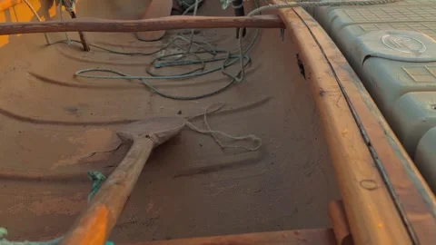 Crawling Shot Over The Middle Of A Canoe With A Rise Up A Sail At The End Stock Footage 255471915