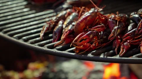 Crayfish are grilling over open flame, heat causing shells to turn vibrant red. Stock Footage 280376633