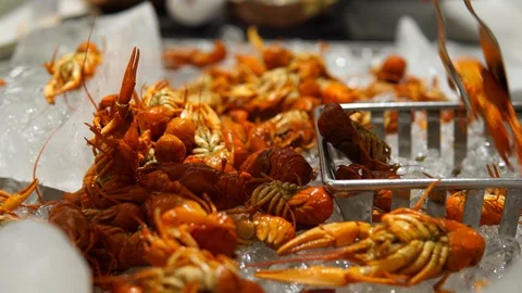 Crayfish in a restaurant buffet. People put seafood in the plates. Video stock 114310368