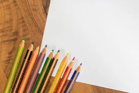 Crayons and paper on table Stock Photos