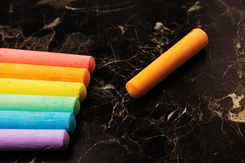 Crayons of different colors placed on a dark background. Education Stock Photos
