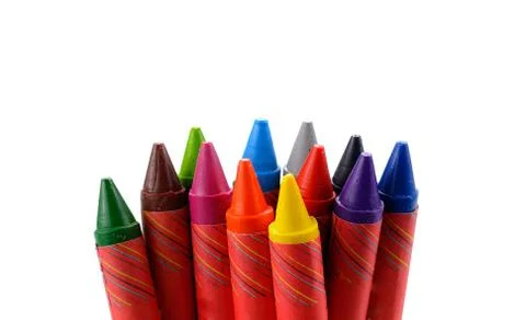 Crayons lined up in rainbow isolated on white background. Stock Photos