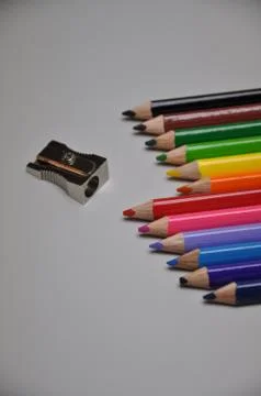 Crayons with sharpener - school supplies Stock Photos