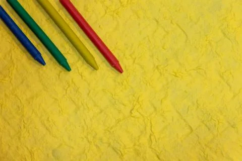 Crayons on textured yellow- Stock Photos