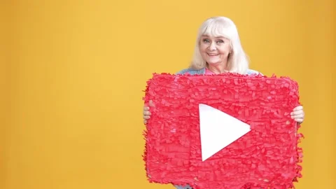 Crazy aged lady dance pinata button play movie isolated bright color background Stock Footage 189782326