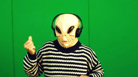 Crazy and funny alien ufo mask people dance and listen song music with headph Stock Footage 167901481