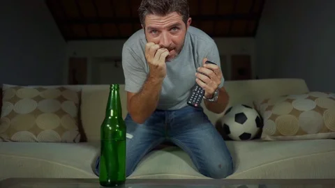 Crazy and nervous man on couch watching tv of football game Stock Footage 113135185