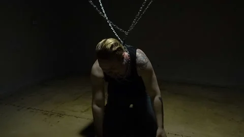 Crazy blond captive bound in chains Stock Footage 95734048