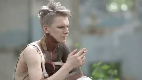 Crazy bloody guy throws a cigarette and puts on the face mask Stock Footage 78200670