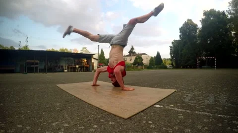 Crazy boy spins on his head on the street Video stock 54231319
