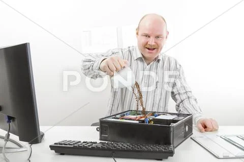 Crazy Businessman Pouring Coffee In Computer Chassis Stock Photos