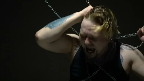Crazy captive bound in chains Stock Footage 95098771