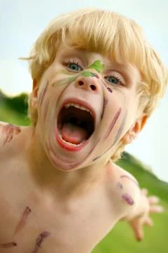 Crazy child with painted face Stock Photos