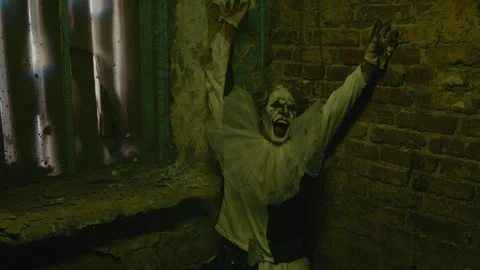Crazy Clown Leaning on Wall and Shouting Stock Footage 250962359