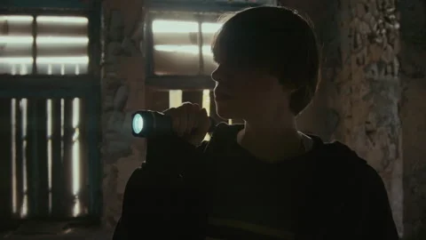 Crazy Clown Putting Transparent Plastic Bag on Girl with Flashlight from Behind Stock Footage 250952609