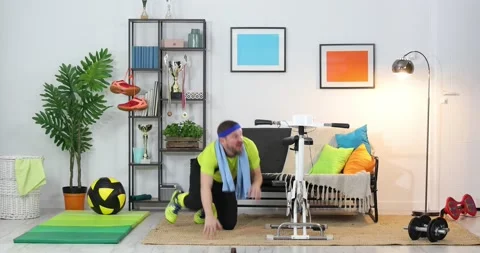 Crazy cyclist rides for snacks. Unsporting guy training his bike at home. Fun Stock Footage 152853885