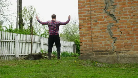 Crazy Farmer simulates the flight of a bird. The man imagines a bird. 스톡 동영상 155128684