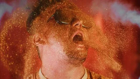 Crazy fun man sprinkles himself with sparkle particles. Fun photo funny face Stock Photos