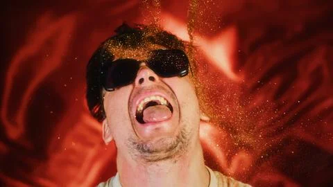 Crazy fun man sprinkles himself with sparkle particles. Fun photo funny face Stock Photos
