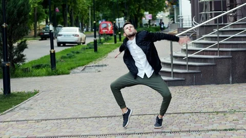 Crazy funny man dancing on the street, very pleased Stock Footage