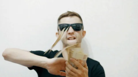 Crazy funny man in sunglasses throws money, luxurious life Stock Footage 111962159