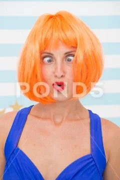 Crazy girl with orange hair. crazy emotions on face of girl. feelings and Stock Photos