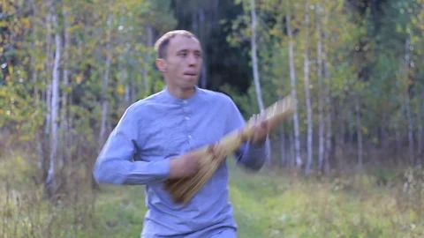 Crazy guy dancing with a broom Stock Footage 95952308