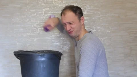 Crazy guy disinfects the trash bin with toilet water. Stock Footage 143588923
