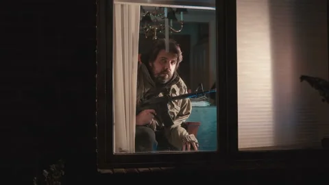 Crazy guy watching out window with gun Vidéo 143171657