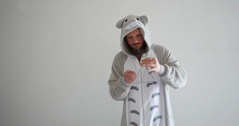 Crazy handsome attractive bearded hipster wearing totoro pajama Stock Footage 116530331