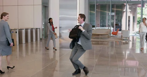 Crazy happy businessman dancing in corporate lobby Stock Footage