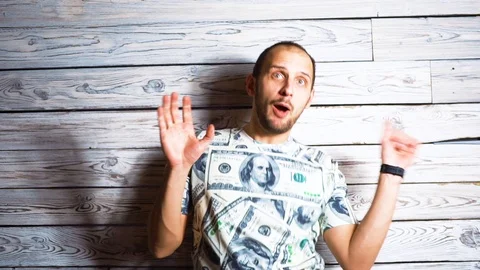 Crazy happy man in dollar t-shirt rejoi at success Smiles and jumps for joy Stock Footage 100850404
