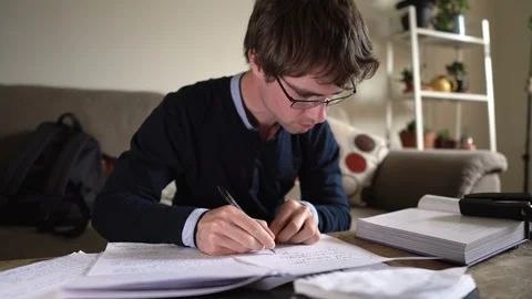 Crazy Hyperactive University Student on Caffeine Scribbling Notes While Studying Stock Footage 121198290