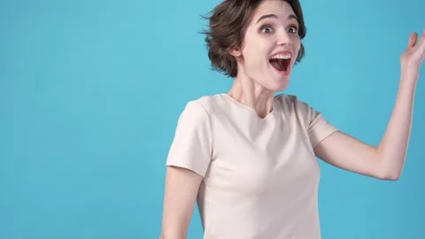 Crazy lady discover incredible ads isolated on blue color background Stock Footage 204989340