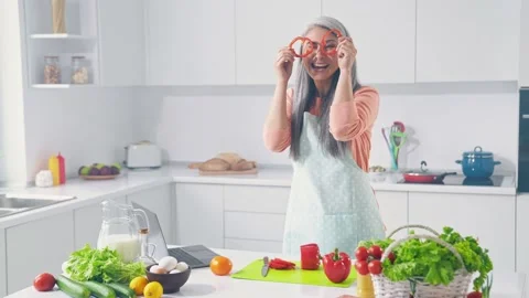 Crazy lady do weightloss supper salad dance red pepper face slices in kitchen Stock Footage 165348777