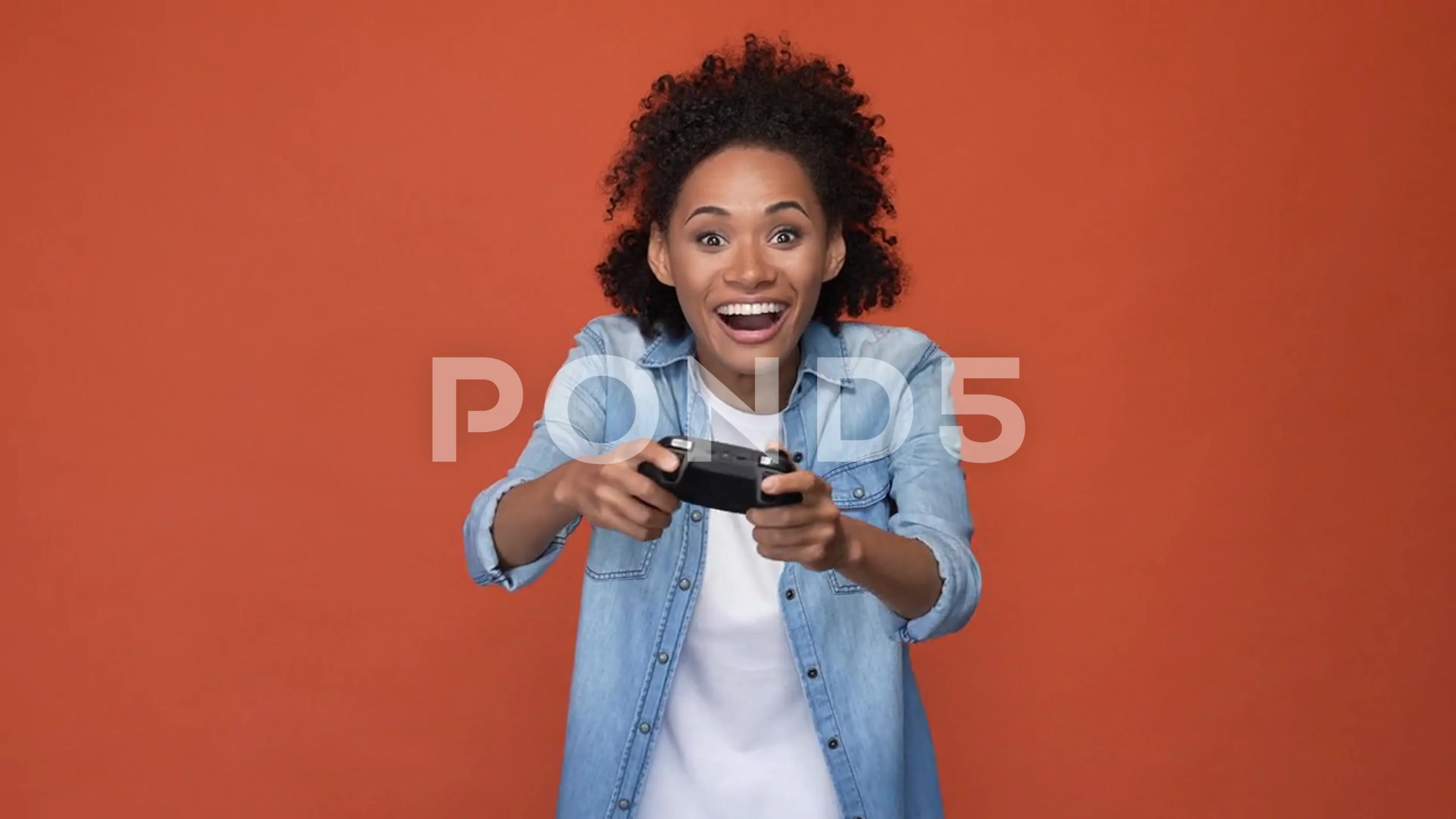 Crazy lady play video game fist up isolated brick color background