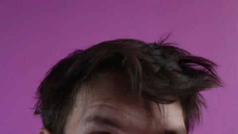 Crazy mad looking man face emotion close up pink background Stock Footage 125460543