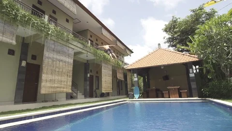Crazy Man Flips into Pool From Balcony Bali Almost Doesnt Make It Stock Footage 106037736