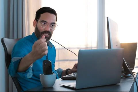Crazy man office work. Work stress. Throwing the mouse in the coffee cup Stock Photos