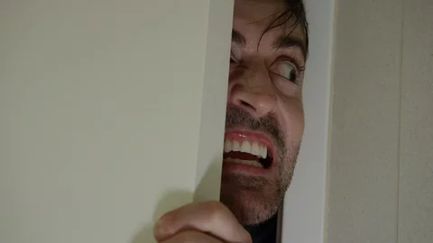A crazy man tries to get into the bathroom to attack his victim. Halloween Stock Footage 117263374