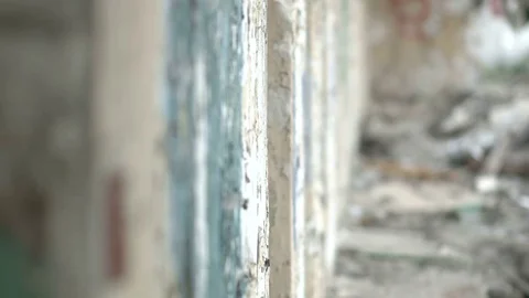 Crazy maniac peeks out from behind the wall and looks into the camera Stock Footage 78195710
