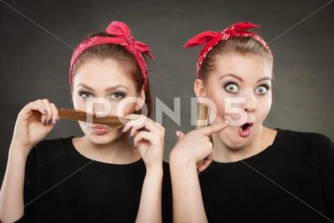 Crazy pin up retro girls making funny faces. Stock Photos