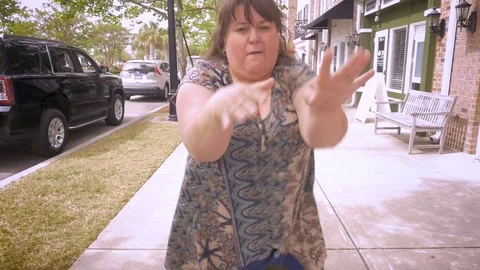 A crazy plus sized woman dancing in the streets celebrating achievement Video stock 75637243