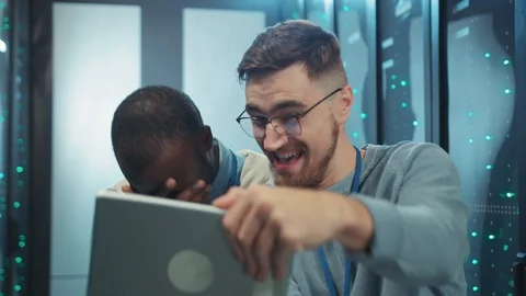 Crazy positive server technicians laughing hard browsing fun content on digital Stock Footage 119843366