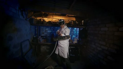 Crazy professor in funny glasses having fun with a vacuum cleaner in his hands. Stock Footage 141257528