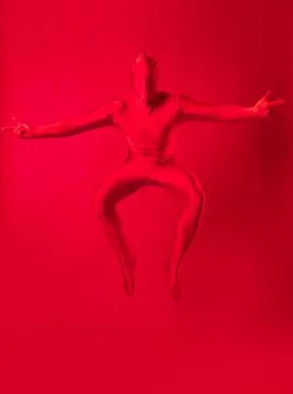 Crazy red man on a red background. figure in a leotard covering the whole body Stock Photos
